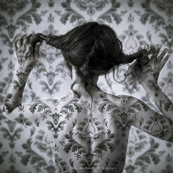 A woman with tattoos on her back and arms.