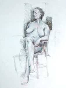 A woman sitting in a chair with her legs crossed.