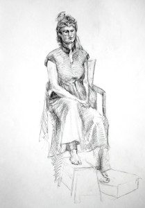 A woman sitting in a chair with her legs crossed.