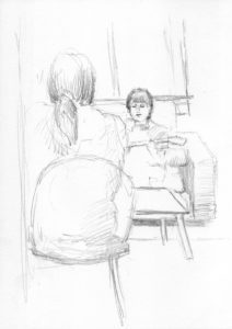 A pencil drawing of two people sitting in front of each other